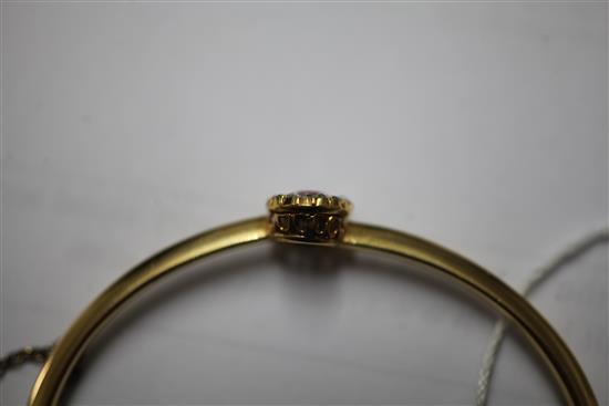 A Victorian gold, ruby and diamond cluster hinged bangle,